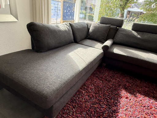 Corner sofa with footstool