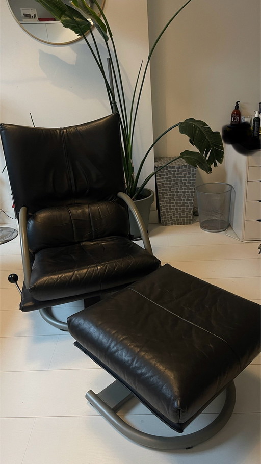 Poltrona e poggiapiedi Torino di Rolf Benz, in pelle nera.