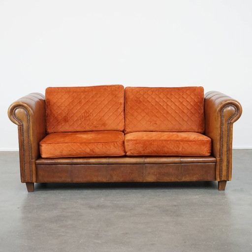 Top-quality 2.5-seater sheepskin sofa with orange fabric seat and back cushions