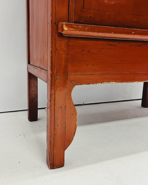 Antique red cabinet with brass details