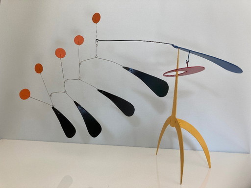 Yellow standing mobile with 5 orange discs