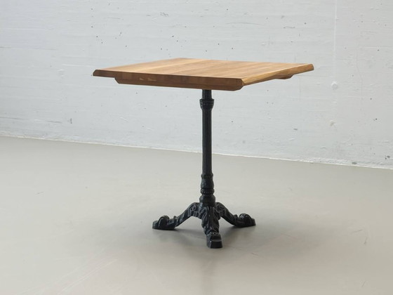 Image 1 of Bistro table made of acacia wood with a cast iron base in country style