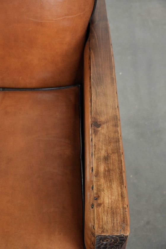 Image 1 of Unieke schapenleren art Deco fauteuil met mooi houtsnijwerk en zwarte biezen