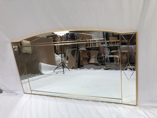 Large faceted mirror framed in brass