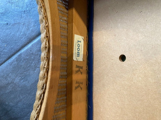 Lloyd Loom chairs, with blue fixed cushions.