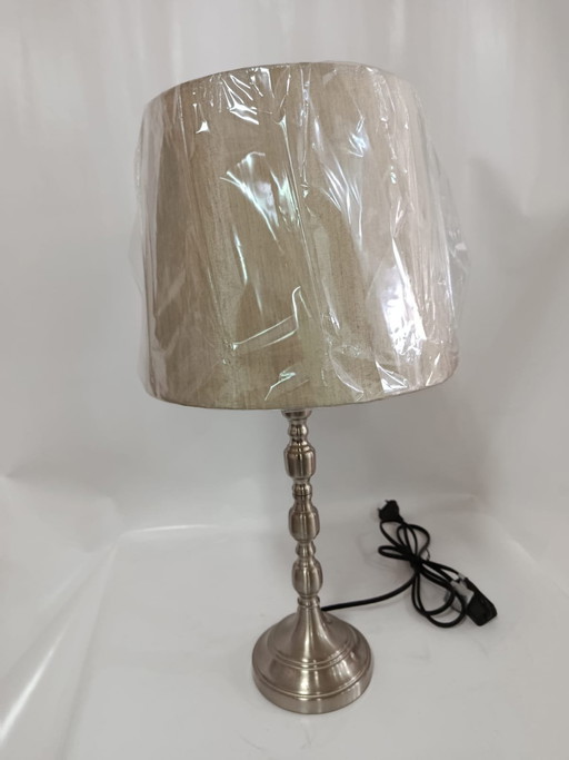 Elegant metallic table lamp with textured beige shade
