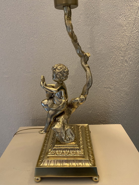 Image 1 of Bronze table lamp depicting a cherub playing the guitar
