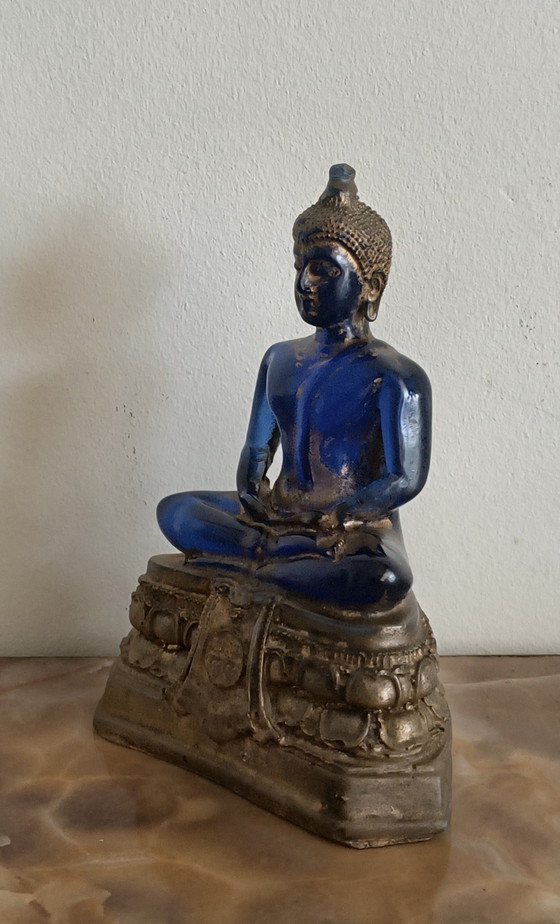 Image 1 of Old Buddha made of blue glass and stone material.