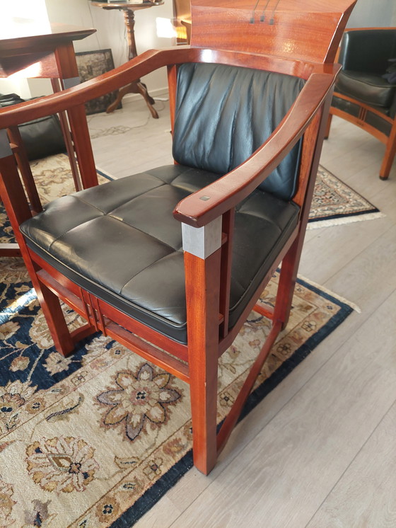 Image 1 of Rectangular long dining table with four luxurious leather-upholstered chairs by Schuitema Stadskanaal. In very good condition.