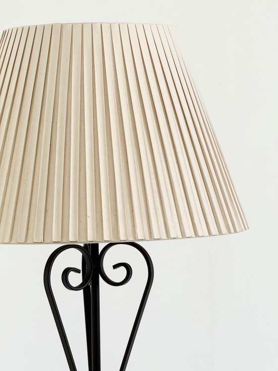 Image 1 of Vintage wrought iron table lamp in a swirl shape with a pleated shade