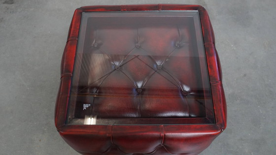 Image 1 of Beef leather chesterfield side/ coffee table in a red color with glass top