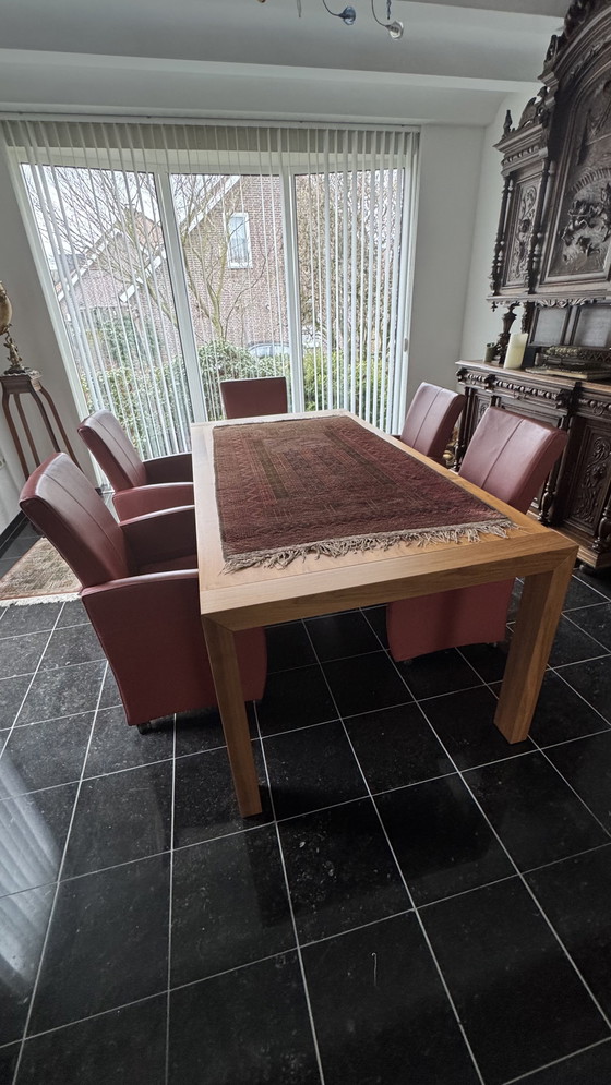 Image 1 of Dining table with 8 leather chairs in my