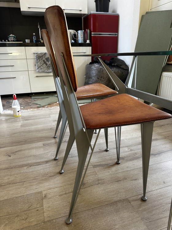 Image 1 of Table de salle à manger design avec 4 chaises en cuir assorties