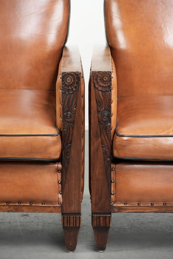 Image 1 of 2 x Prachtige schapenleren Art Deco fauteuil met mooi houtsnijwerk en zwarte biezen