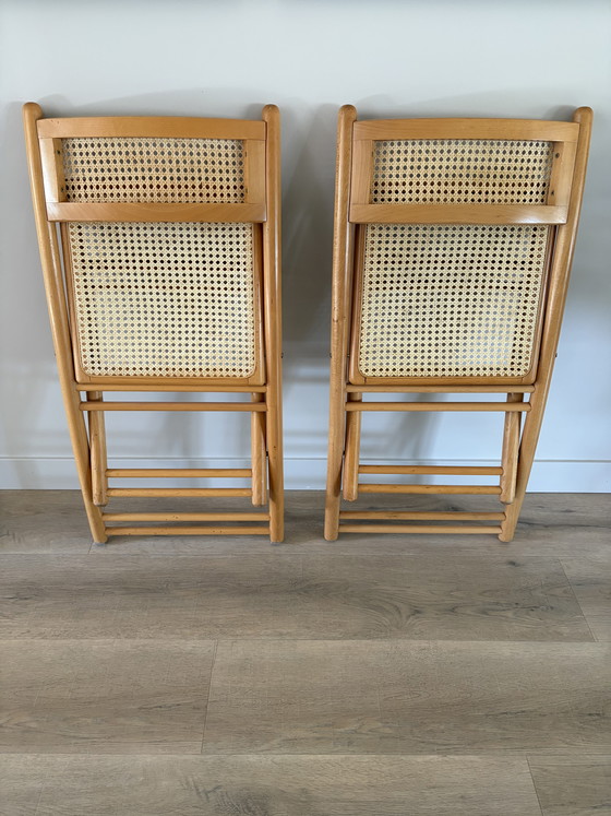 Image 1 of Twee vintage inklapbare houten met webbing stoelen 