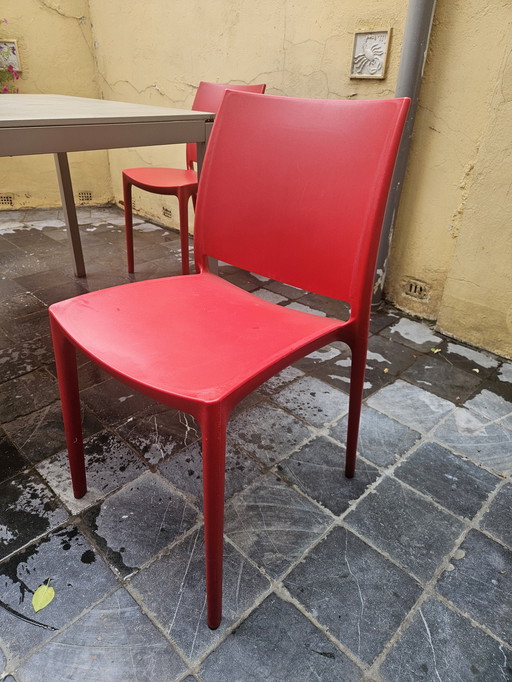 Gray garden table with 4 red garden chairs