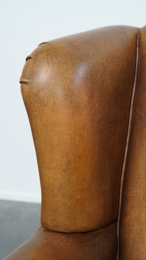 Image 1 of Karaktervolle vintage schapenleren oorfauteuil met een mooi patina
