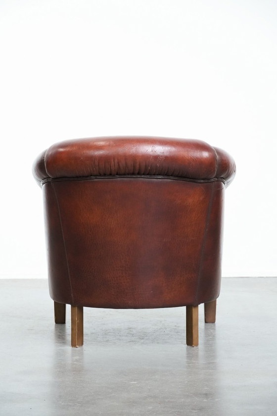 Image 1 of Vintage clubfauteuil gemaakt van schapenleer met siernagels