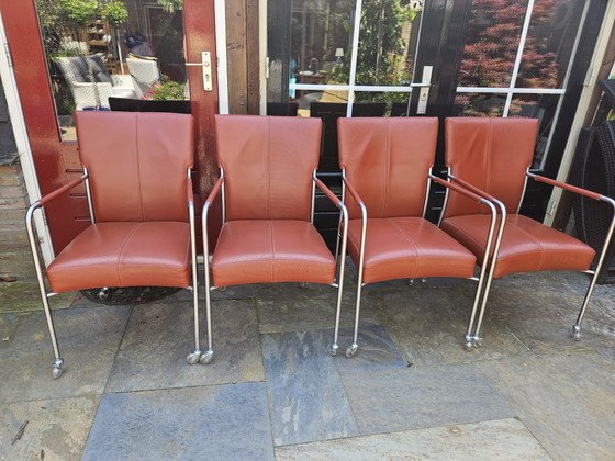 Image 1 of 4 red leather dining chairs on wheels, brand Bert Plantagie