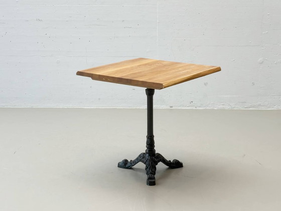 Image 1 of Bistro table made of acacia wood with a cast iron base in country style