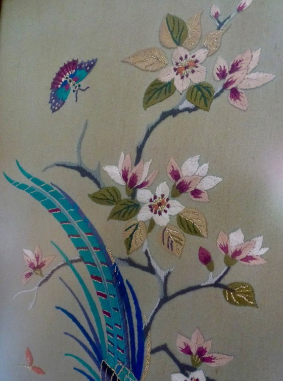 Image 1 of Vintage hand-embroidered wall tapestry, behind glass, with a crane, butterflies and flowers.