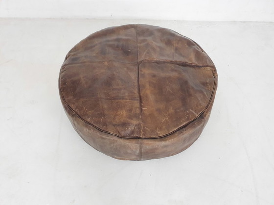 Image 1 of Dark brown leather ottoman. In good vintage condition