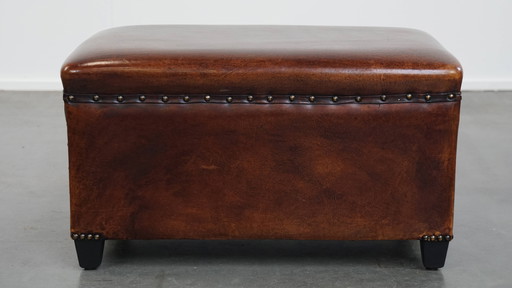 Cognac-colored sheep leather hocker with decorative rivets