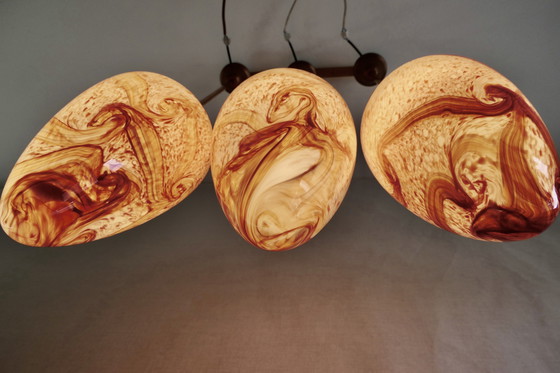 Image 1 of Drie Sfeervolle Druppelvormige Hanglampen van Rood Gemarmerd Opaline Glas