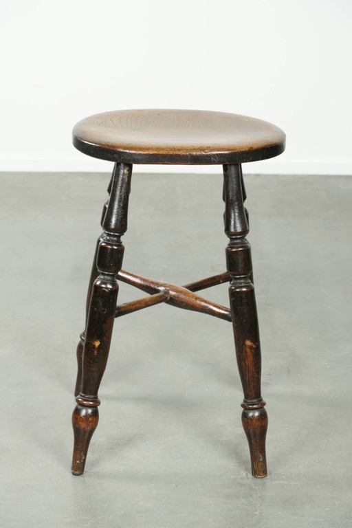 Antique English Windsor stool from the early 19th century with a unique oval shape