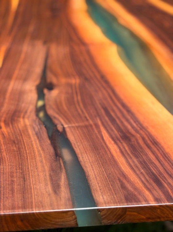 Image 1 of Dining table in American walnut and maple. Handcrafted solid wood extensions and drawers. Live edge for visual depth. Epoxy resi