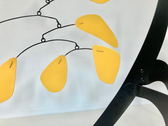 Image 1 of Black stabile with 9 yellow discs and leaves