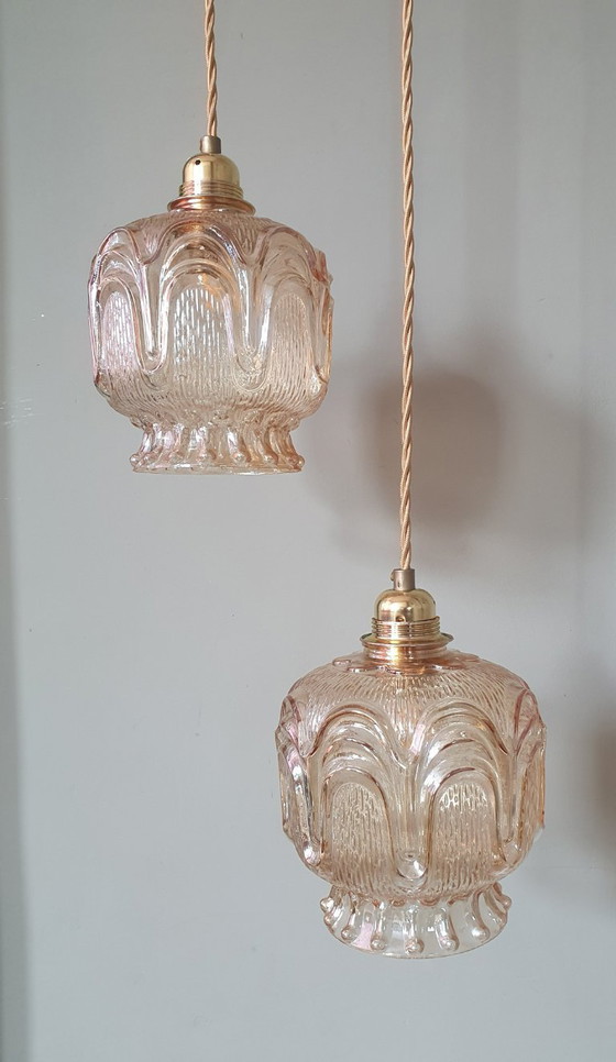 Image 1 of Set of 2 Vintage textured rose / amber tinted pendant lamps - mid-century design.