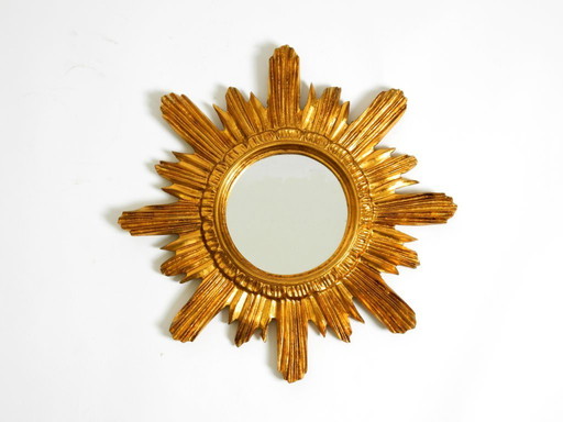 Beautiful Italian Mid Century Sunburst wall mirror made of wood and resin, gold-plated
