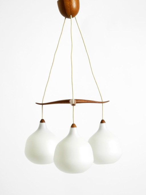 Beautiful pendant lamp with three opal glass shades and a teak frame by Uno & Östen Kristiansson for Luxus Vittsjö, Sweden 1957