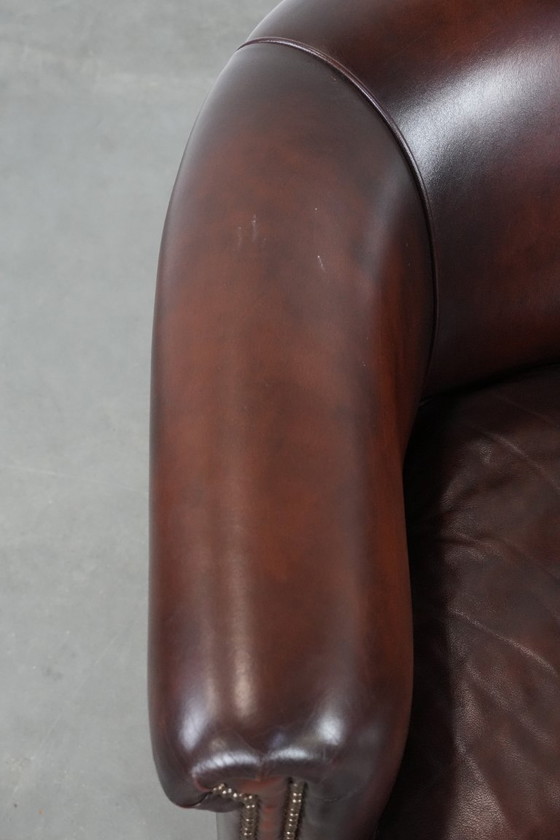 Image 1 of Sillón club de piel de vaca en buen estado, de un lujoso color rojo/marrón.