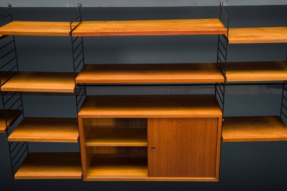 Image 1 of Modulaire wandplank in teak van Nils Strinning voor String, 1960, set van 29