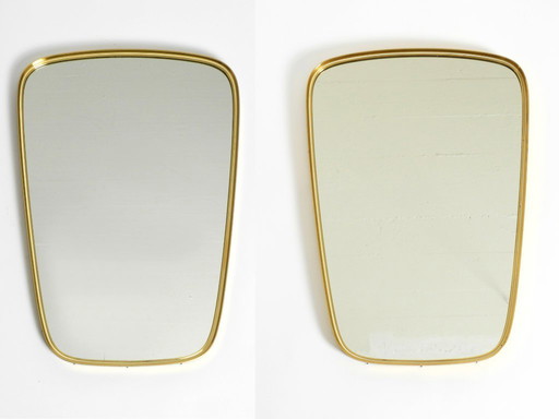 A pair of rare original Mid Century Modern "Münchener Zierspiegel" wall mirrors with heavy brass frames