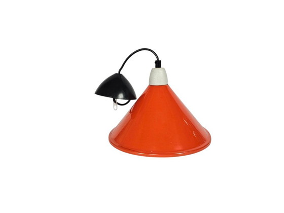Image 1 of Suspension en métal au design industriel | orange | douille en porcelaine | années 80