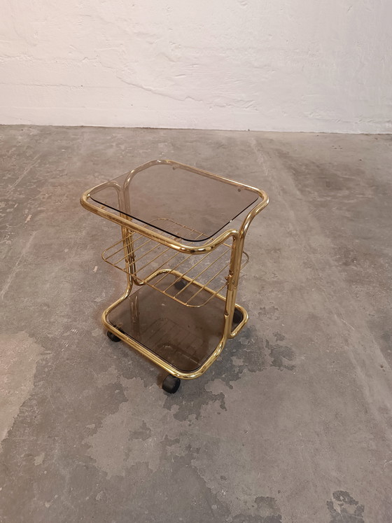 Image 1 of Vintage gold coloured and glass trolley side table 