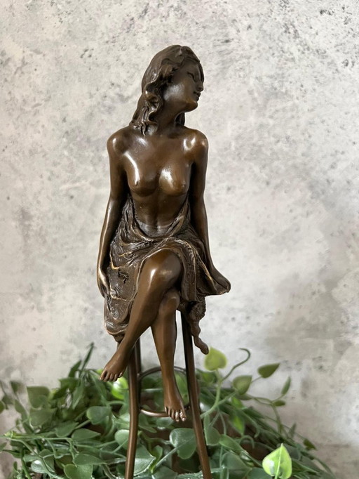 Bronzestatue einer Dame auf einem Stuhl