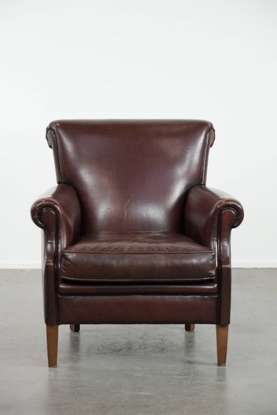 Image 1 of Donkere luxe schapenleren fauteuil/ armchair met een tijdloze uitstraling