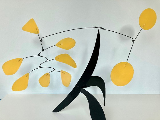 Image 1 of Black stabile with 9 yellow discs and leaves