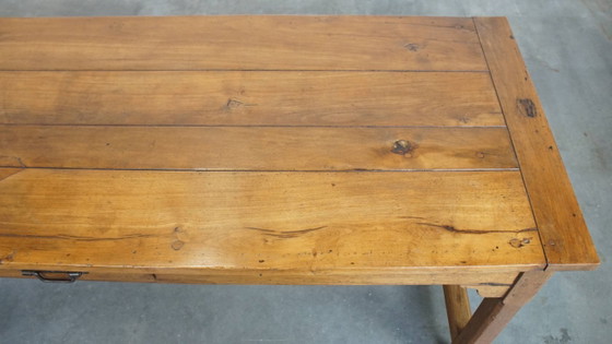 Image 1 of Large antique French farmhouse dining table made of fruitwood from the late 18th century with beautiful and original details.