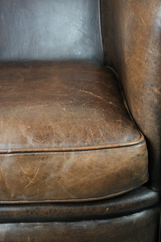 Image 1 of Sturdy and characterful vintage sheepskin club armchair