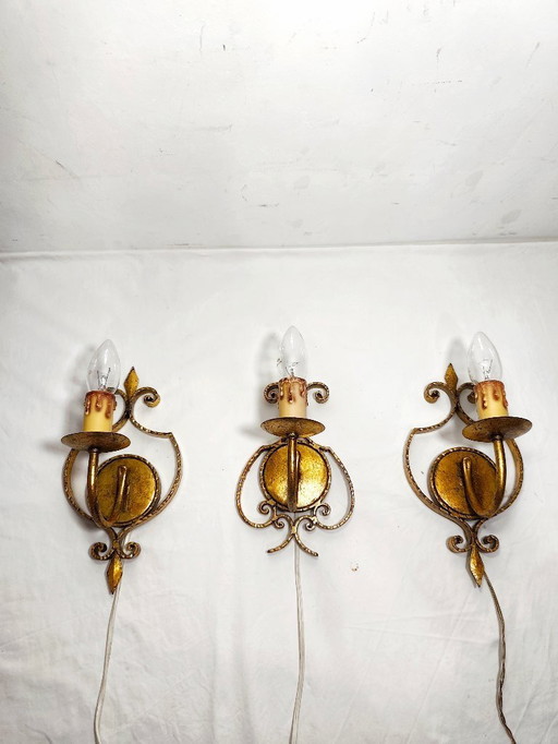 Wrought iron and gold leaf wall lights. Spain, 1960s.