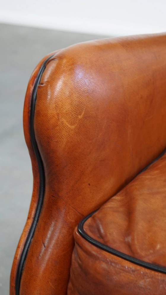 Image 1 of Schapenleren armchair met hoge rug en zwarte biezen 