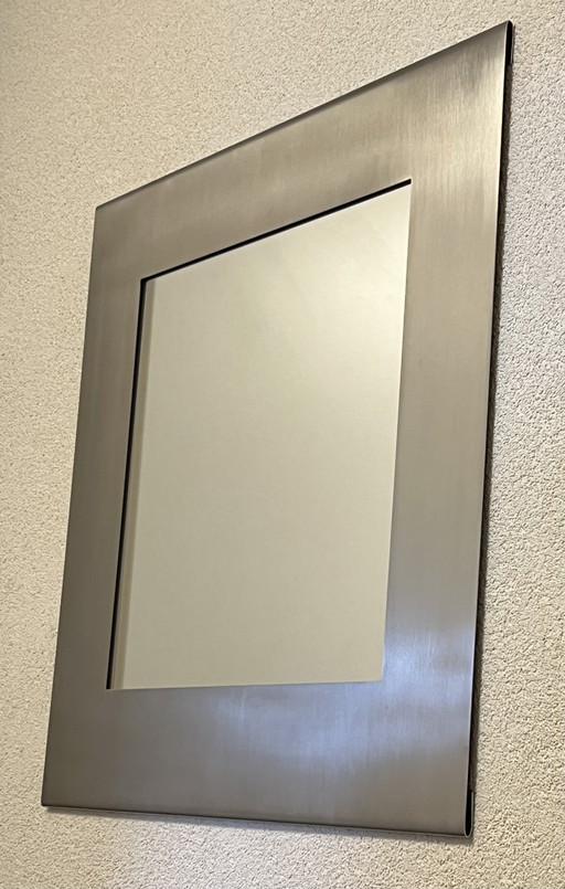 Design mirror in sleek stainless steel frame