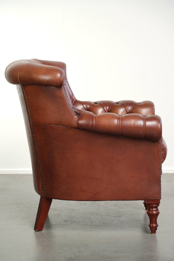 Kwalitatief zeer goede cognac kleurige rundleren chesterfield armchair in Engelse stijl met een tijdloos (photo 3 of 12)