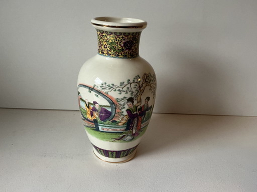 Porcelain vase decorated with a garden scene and figures