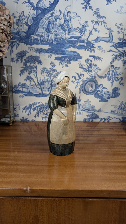 Denbac pour Noyer Berrichonne shepherdess anthropomorphic liqueur bottle, early 20th century ceramics
